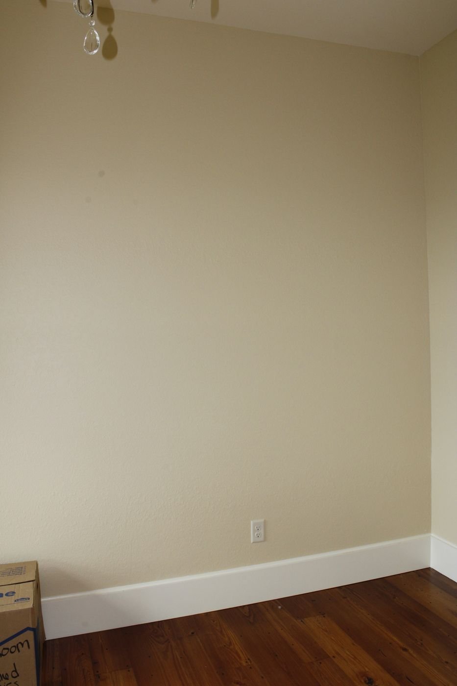 Baseboard trim detail along a painted wall