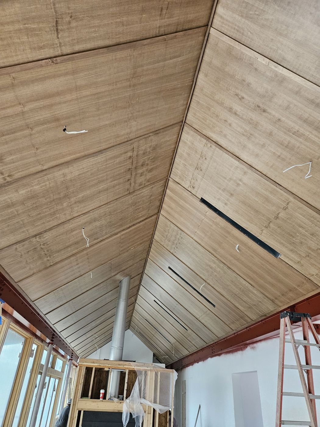 Wood plank ceiling installation in progress