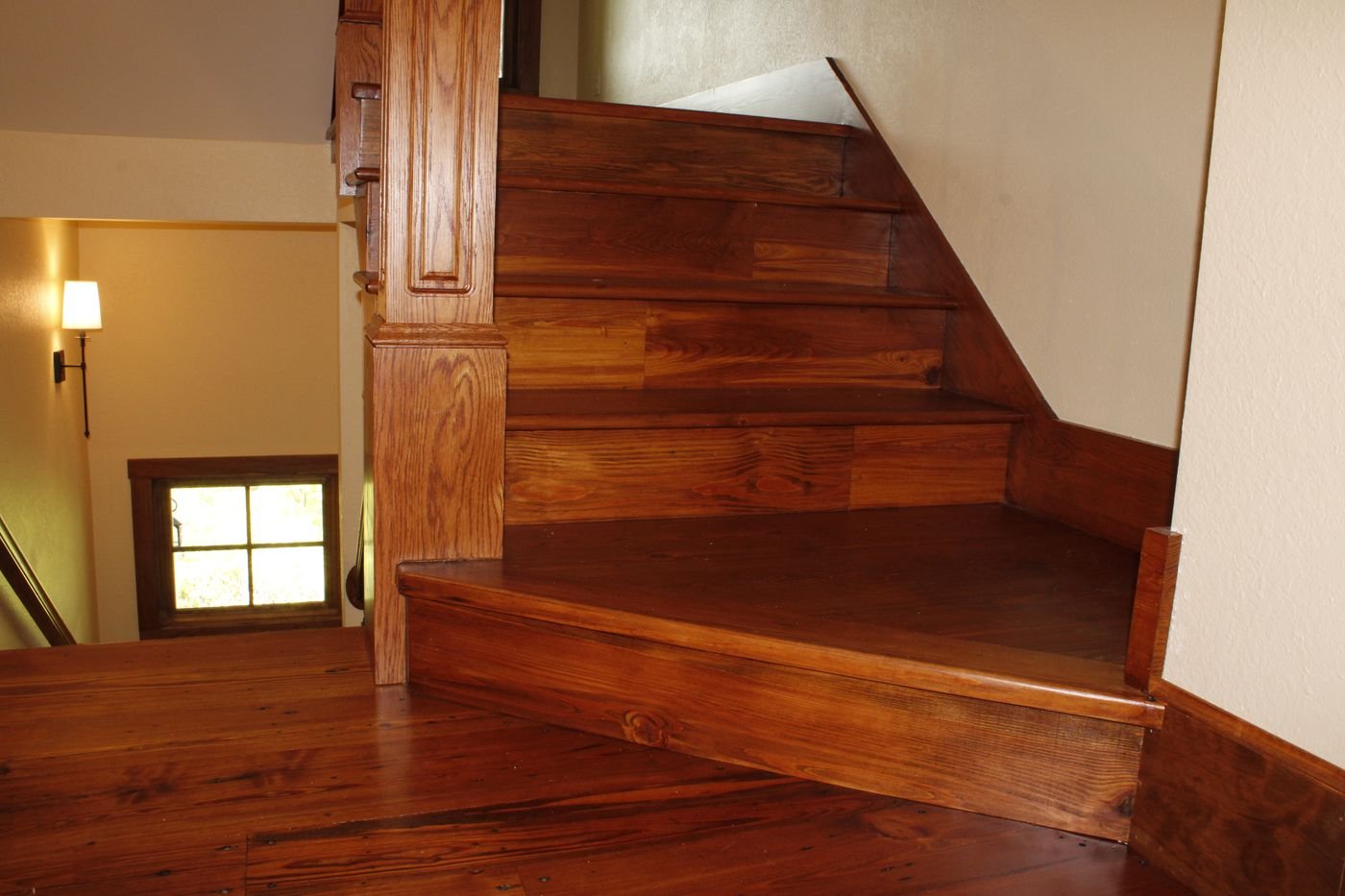 Curved bottom stair tread in polished hardwood