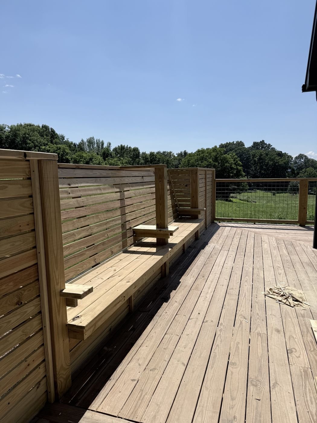Custom wood deck bench and privacy wall with slat design