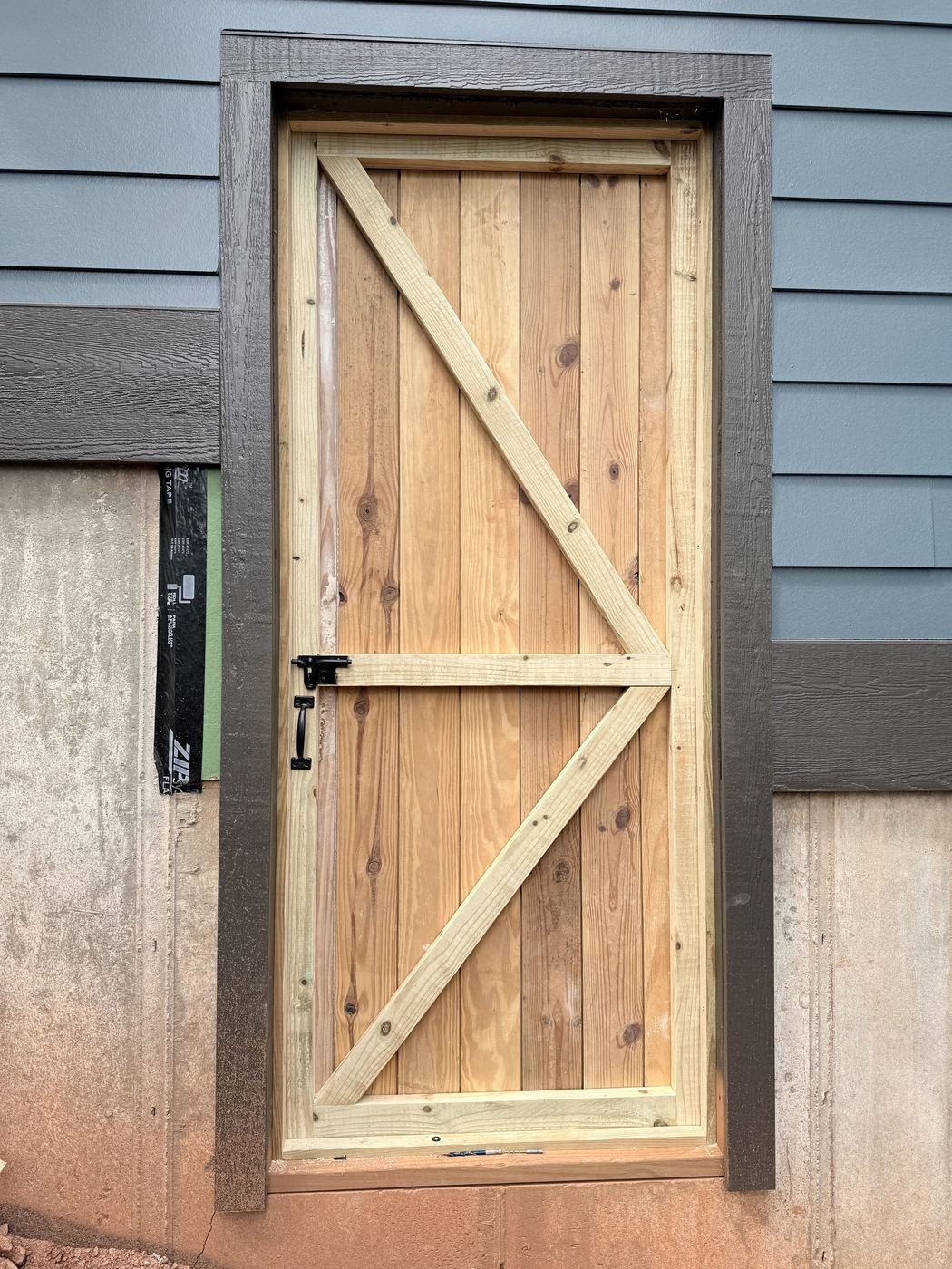 Custom built solid wood exterior door with cedar plank and Z-brace design