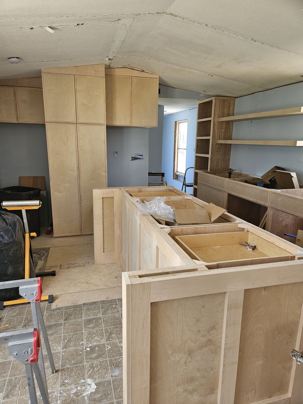 Kitchen cabinetry and island installation in progress