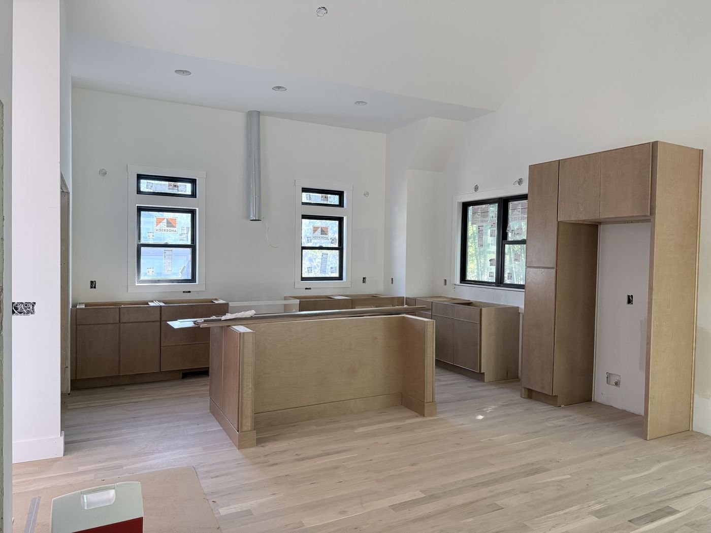 Kitchen cabinet installation in progress with island framing