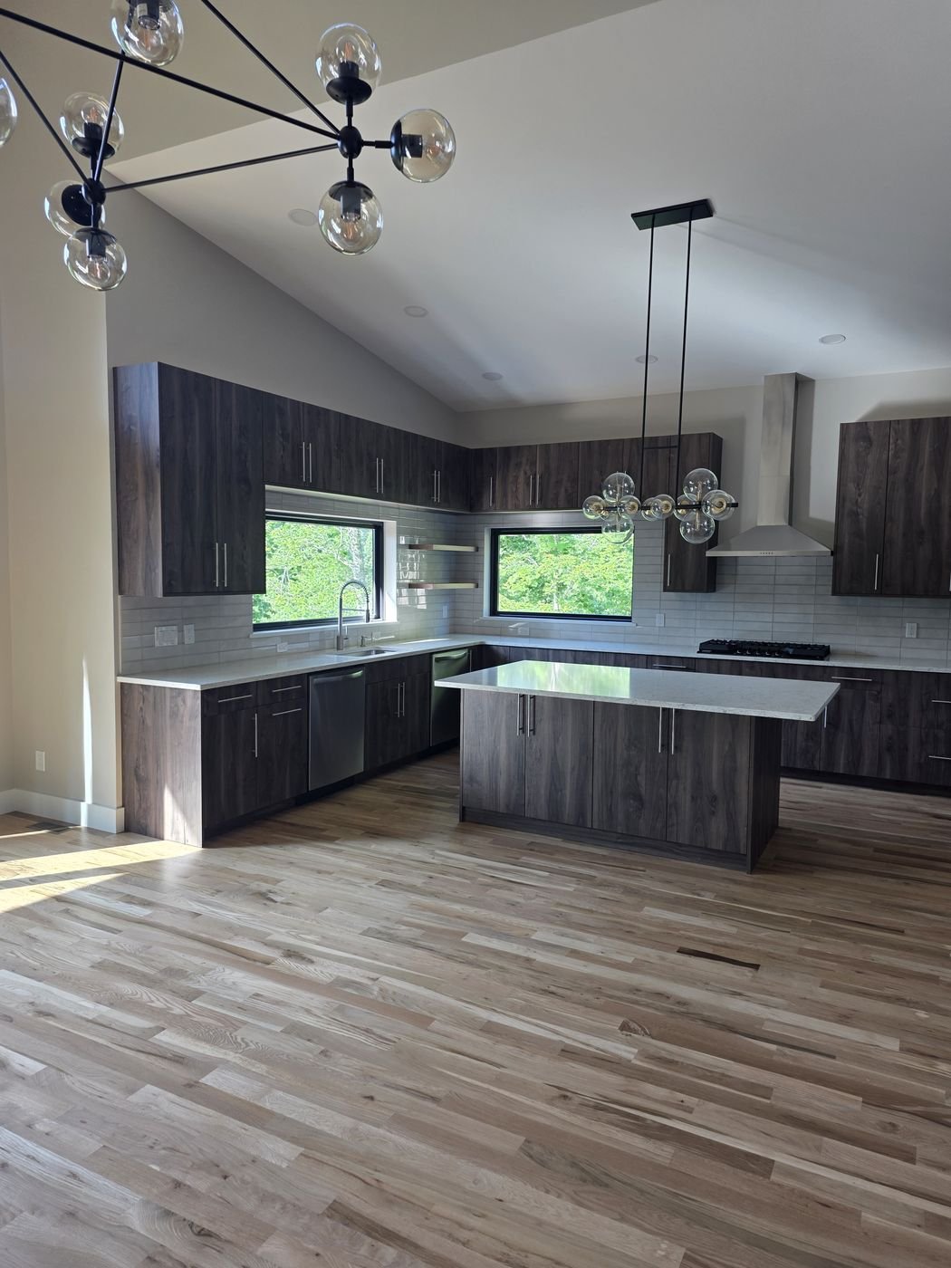 Modern dark wood kitchen cabinetry with center island