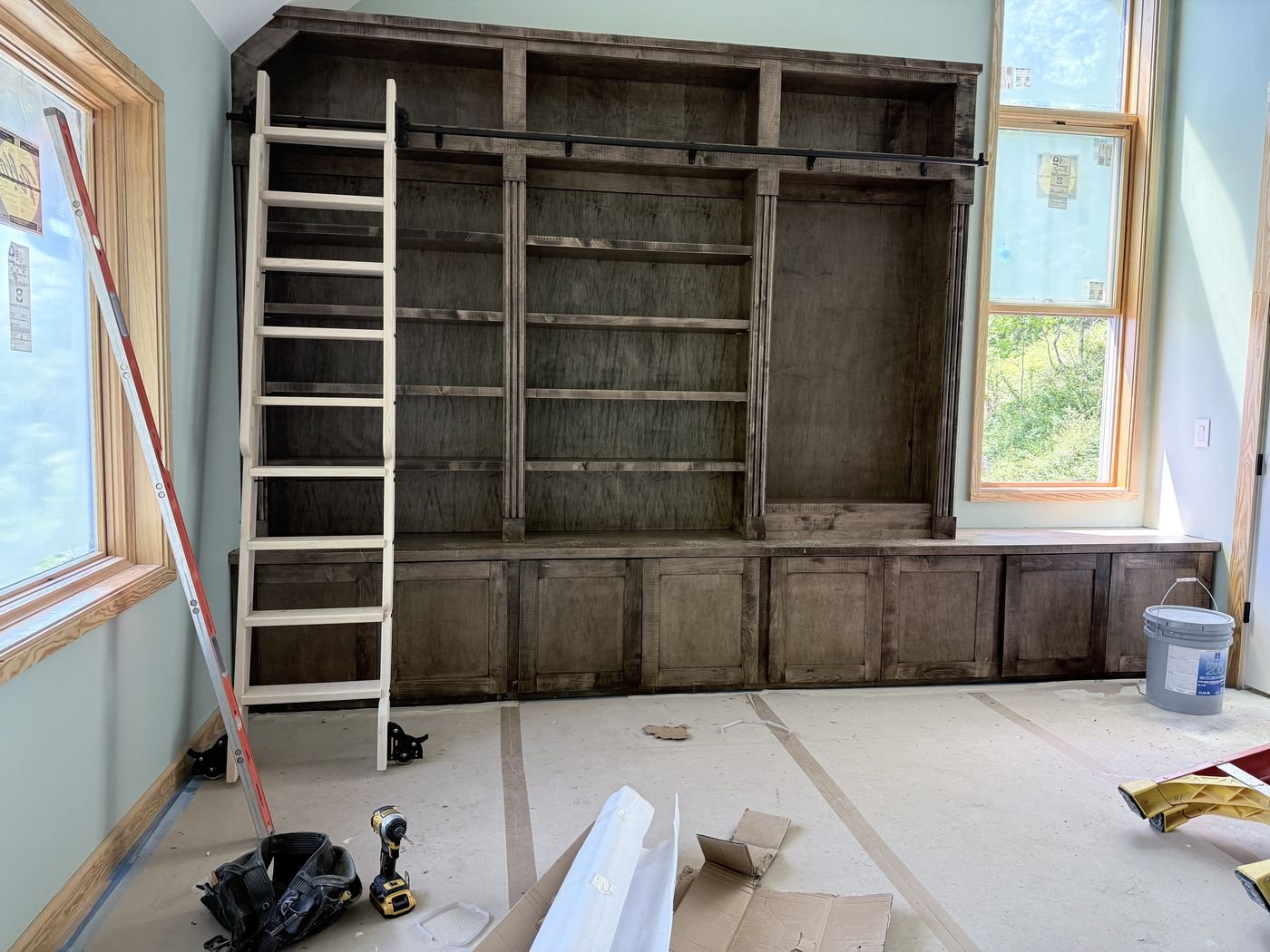 Built-in library shelving with rolling ladder