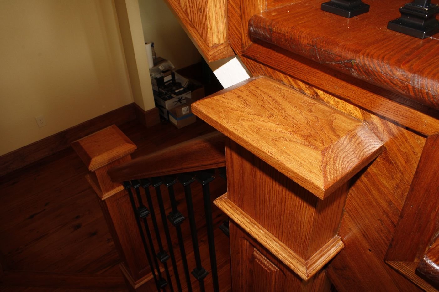 Decorative newel post cap detail in stained oak