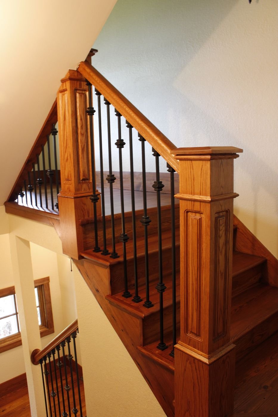 Oak stair newel post overlooking a staircase landing