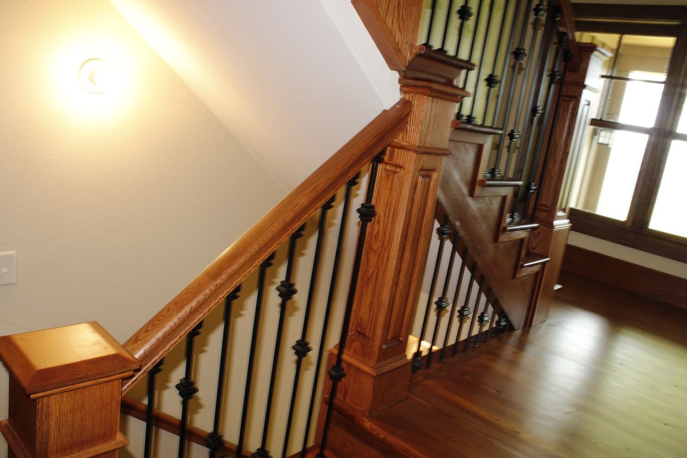 Staircase with oak newel posts and iron balusters