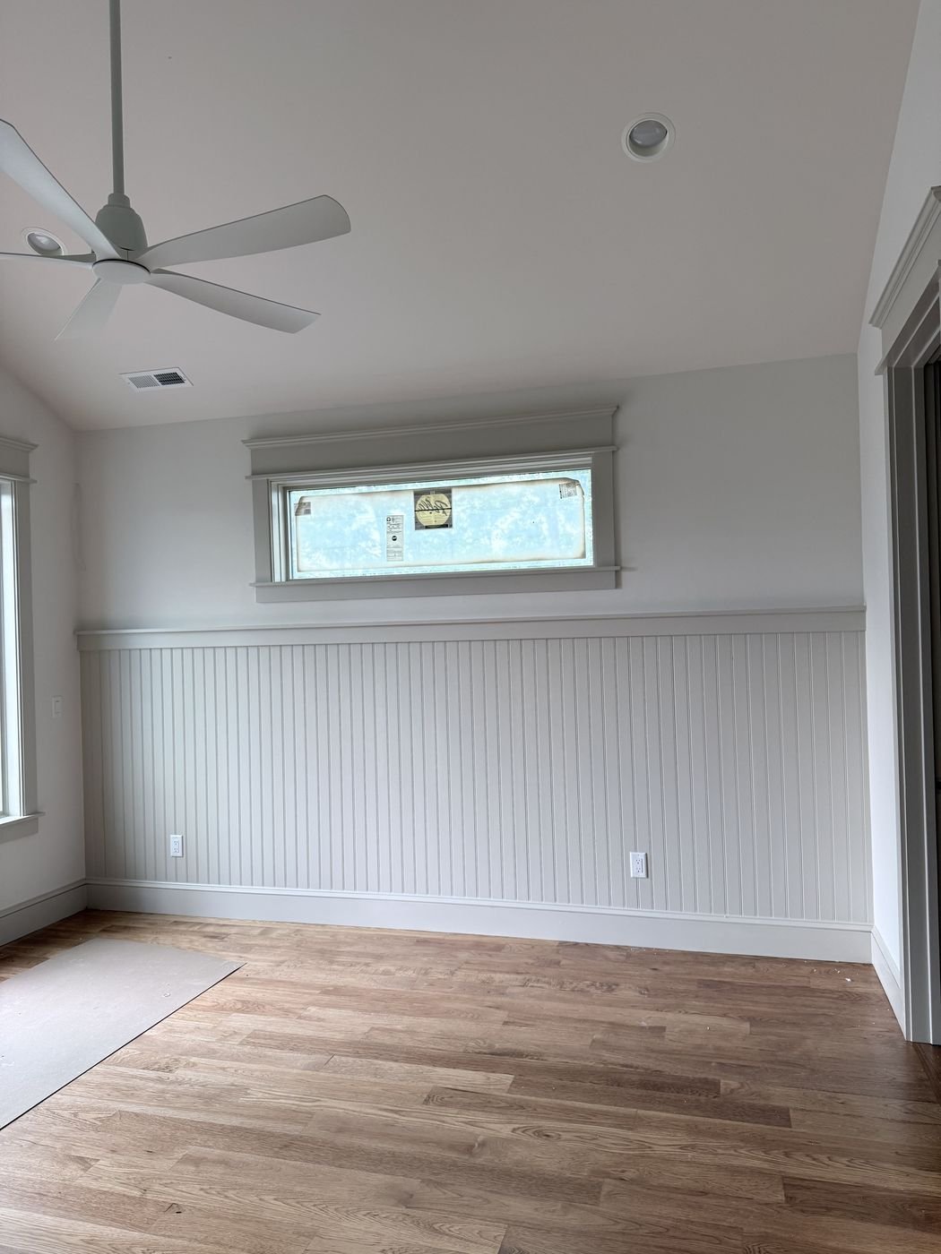 Beadboard wainscoting and trim installed around a window
