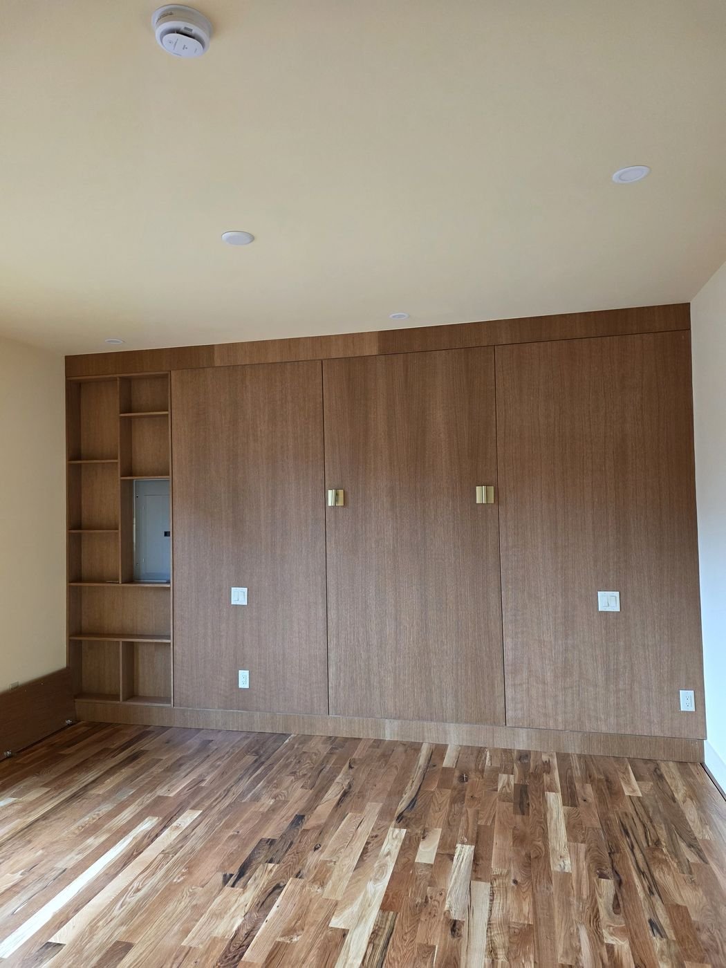 Custom built-in wardrobe cabinetry with wood-grain finish