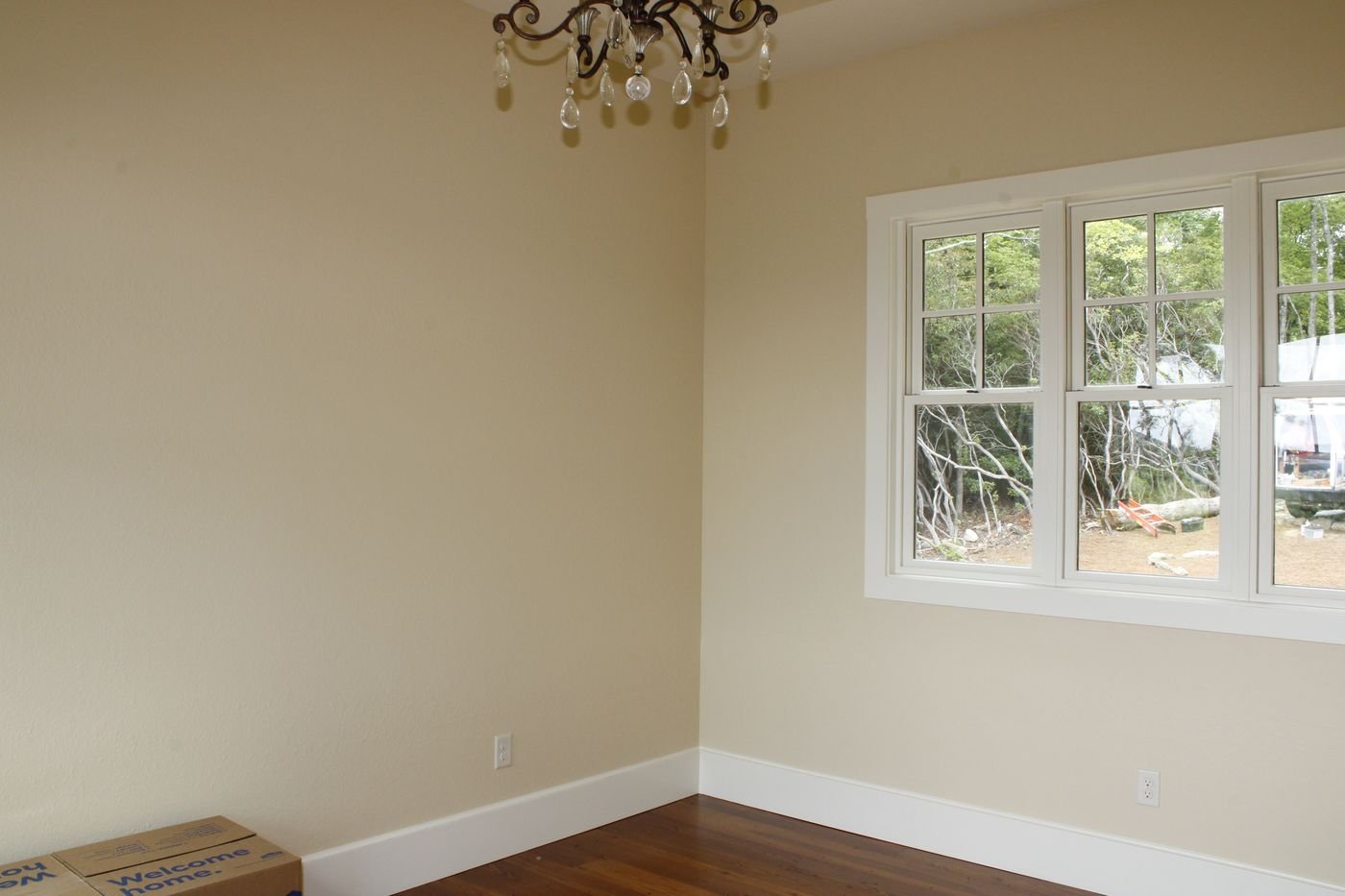 Window casing and baseboard trim in a bedroom corner